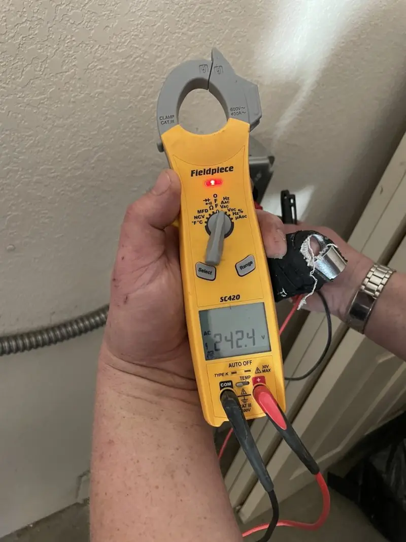 Voltage testing with clamp meter during Recessed Lighting Installation in Skaneateles